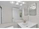 Bathroom with updated vanity and large mirror at 1127 Pine Ridge W Cir # A2, Tarpon Springs, FL 34688