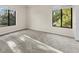 Spacious bedroom with neutral carpeting and large windows at 1127 Pine Ridge W Cir # A2, Tarpon Springs, FL 34688