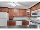 Well-equipped kitchen featuring ample cabinetry and modern appliances at 1127 Pine Ridge W Cir # A2, Tarpon Springs, FL 34688