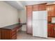 Efficient galley kitchen with wood cabinets and modern appliances at 1127 Pine Ridge W Cir # A2, Tarpon Springs, FL 34688