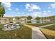 Peaceful lakefront view with a seating area and lush green space at 1127 Pine Ridge W Cir # A2, Tarpon Springs, FL 34688