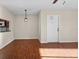 Dining area with wood-look floors and access to kitchen at 1127 Pine Ridge W Cir # A2, Tarpon Springs, FL 34688