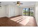 Bright living room with wood-look floors and sliding glass doors at 1127 Pine Ridge W Cir # A2, Tarpon Springs, FL 34688