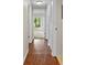 Long hallway with wood-look flooring and access to other rooms at 1127 Pine Ridge W Cir # A2, Tarpon Springs, FL 34688