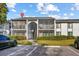 Condo building exterior with parking and landscaping at 1127 Pine Ridge W Cir # A2, Tarpon Springs, FL 34688