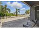 Large back patio area with brick pavers, outdoor seating, and palm trees at 12013 Whistling Wind Dr, Riverview, FL 33579