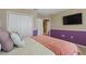 Bedroom featuring a comfortable bed, colorful walls, and a flat-screen TV for relaxation and entertainment at 12013 Whistling Wind Dr, Riverview, FL 33579
