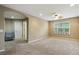 Empty bedroom featuring carpet floors, natural light from the window, and a ceiling fan at 12013 Whistling Wind Dr, Riverview, FL 33579