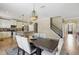 Dining room area connected to the kitchen, featuring a dark wood table with chairs, and modern chandelier at 12013 Whistling Wind Dr, Riverview, FL 33579