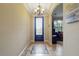 Inviting foyer with tile flooring, mosaic design, and a decorative chandelier, leading to the living area at 12013 Whistling Wind Dr, Riverview, FL 33579