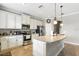 Bright kitchen featuring stainless steel appliances, white cabinets, granite countertops, and a large island at 12013 Whistling Wind Dr, Riverview, FL 33579