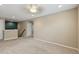 An open living room with beige walls, carpeted floors, and a ceiling fan, offering a cozy and inviting space at 12013 Whistling Wind Dr, Riverview, FL 33579