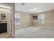 Main bedroom with two windows, neutral colored walls, and access to the main bath at 12013 Whistling Wind Dr, Riverview, FL 33579