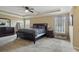 A spacious main bedroom with a tray ceiling, and a dark wood bedroom set at 12013 Whistling Wind Dr, Riverview, FL 33579