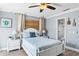 Charming bedroom with white bedroom set, en-suite bathroom, and ceiling fan at 19807 Gulf Blvd # 128, Indian Shores, FL 33785