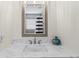 Bathroom with single vanity, marble countertop, and framed mirror at 19807 Gulf Blvd # 128, Indian Shores, FL 33785