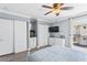 Bright bedroom with white built-ins, large TV, and access to balcony at 19807 Gulf Blvd # 128, Indian Shores, FL 33785