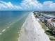 Drone view of beach with people enjoying the sand and ocean at 19807 Gulf Blvd # 128, Indian Shores, FL 33785