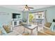 Living room with balcony access and light decor at 19807 Gulf Blvd # 128, Indian Shores, FL 33785