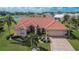 Aerial view of a beautiful home community with golf course and lake at 2009 Captiva Ct, Sun City Center, FL 33573