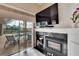 Gathering room with fireplace, large TV, and sliding glass doors leading to a pool at 2009 Captiva Ct, Sun City Center, FL 33573