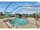 Relaxing kidney-shaped pool with screened enclosure at 2009 Captiva Ct, Sun City Center, FL 33573