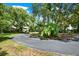 Circular driveway leading to a home with tropical landscaping at 20333 Moss Branch Ct, Lutz, FL 33558