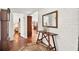 Entryway with brick flooring, wooden console table, mirror, and views of dining and bedroom at 20333 Moss Branch Ct, Lutz, FL 33558