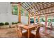 An outdoor living space with a tile floor, a dining table, and comfortable seating areas for relaxing and entertaining at 20333 Moss Branch Ct, Lutz, FL 33558