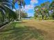 Backyard view with a lake and mature trees at 2421 E Del Webb Blvd, Sun City Center, FL 33573