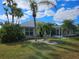 Backyard view showing lush landscaping and a screened enclosure at 2421 E Del Webb Blvd, Sun City Center, FL 33573