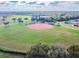 Community baseball field with players and surrounding landscape at 2421 E Del Webb Blvd, Sun City Center, FL 33573