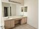 Double vanity bathroom with large mirror and tile flooring at 2421 E Del Webb Blvd, Sun City Center, FL 33573