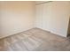 Simple bedroom with double door closet and neutral carpeting at 2421 E Del Webb Blvd, Sun City Center, FL 33573