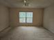 Spacious bedroom with ceiling fan and window coverings at 2421 E Del Webb Blvd, Sun City Center, FL 33573