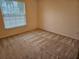 Bright bedroom with neutral carpeting and large window at 2421 E Del Webb Blvd, Sun City Center, FL 33573