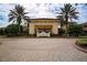 Elegant clubhouse entrance with palm trees and paved driveway at 2421 E Del Webb Blvd, Sun City Center, FL 33573