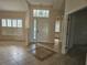 Bright and spacious entryway with tile flooring and a view of the living room at 2421 E Del Webb Blvd, Sun City Center, FL 33573