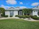 Single-story house with neatly trimmed shrubs and lawn at 2421 E Del Webb Blvd, Sun City Center, FL 33573