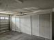 Garage with four storage cabinets and an open garage door at 2421 E Del Webb Blvd, Sun City Center, FL 33573