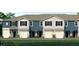 Townhouses with two stories, attached garages, and neutral colors at 2460 Mellow Ln, Clearwater, FL 33765