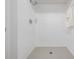 Walk-in shower with white tile and gray floor at 2582 Bentley Dr, Palm Harbor, FL 34684