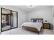 Bedroom with queen-size bed and sliding glass doors to patio at 2582 Bentley Dr, Palm Harbor, FL 34684