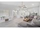 Bright living room with L-shaped sofa and wood-look floors at 2582 Bentley Dr, Palm Harbor, FL 34684