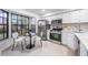 Bright kitchen with white cabinets, stainless steel appliances, and a breakfast nook at 2582 Bentley Dr, Palm Harbor, FL 34684