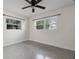Bright bedroom featuring a ceiling fan, and two windows that allow natural light at 3612 W Leila Ave, Tampa, FL 33611