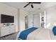 Bright bedroom featuring a ceiling fan, white walls, and ample closet space with easy access to an ensuite bathroom at 3612 W Leila Ave, Tampa, FL 33611