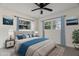 Bright bedroom featuring large windows, a soft bed with throw pillows, and stylish decor at 3612 W Leila Ave, Tampa, FL 33611