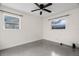 Bright bedroom featuring a ceiling fan and two windows at 3612 W Leila Ave, Tampa, FL 33611