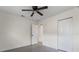 Spacious bedroom featuring a ceiling fan, plenty of natural light, and a double-door closet at 3612 W Leila Ave, Tampa, FL 33611